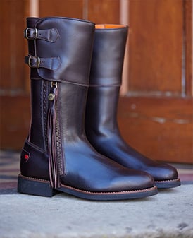Brown leather biker boots with tassel and orange lining